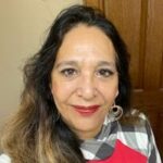 Smiling woman with long hair and hoop earrings