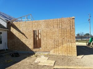 House under construction with wooden panel walls.