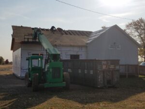 Construction workers repairing roof, Washington Township Hall.