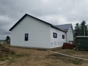 House under construction with white siding