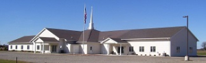 Large suburban church with American flag outside.