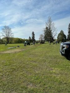 People and trucks on a grassy field