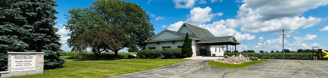 Country church with trees and blue sky