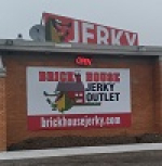 Brick House Jerky Outlet sign on building exterior.